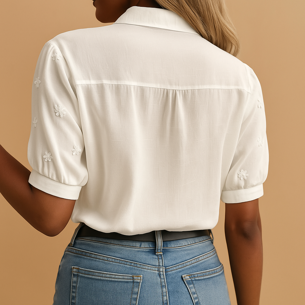White elegant women’s blouse with classic collar and button closure, perfect for work, leisure, or evening occasions.