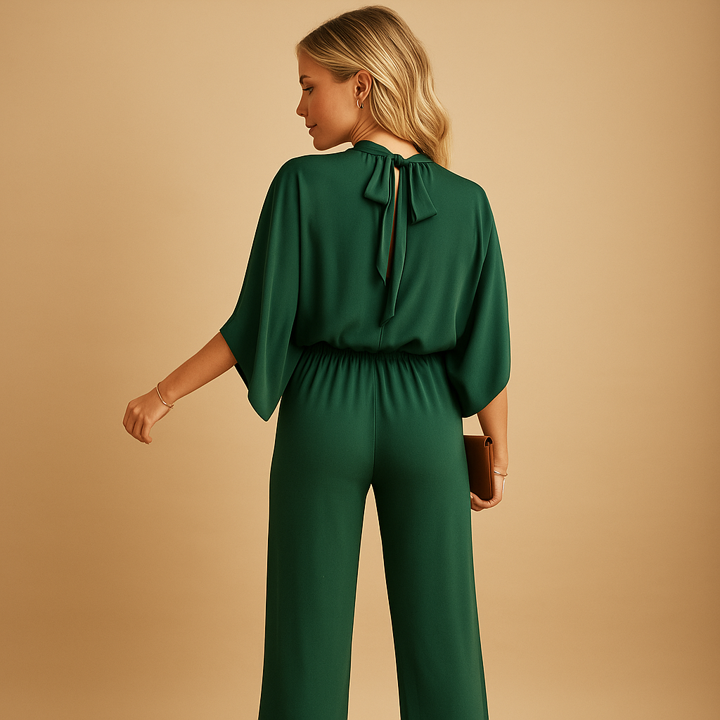 Women’s long sleeve wide leg jumpsuit in green with a relaxed fit and cinched waist. Perfect for elegant daywear, dinners, and formal occasions.