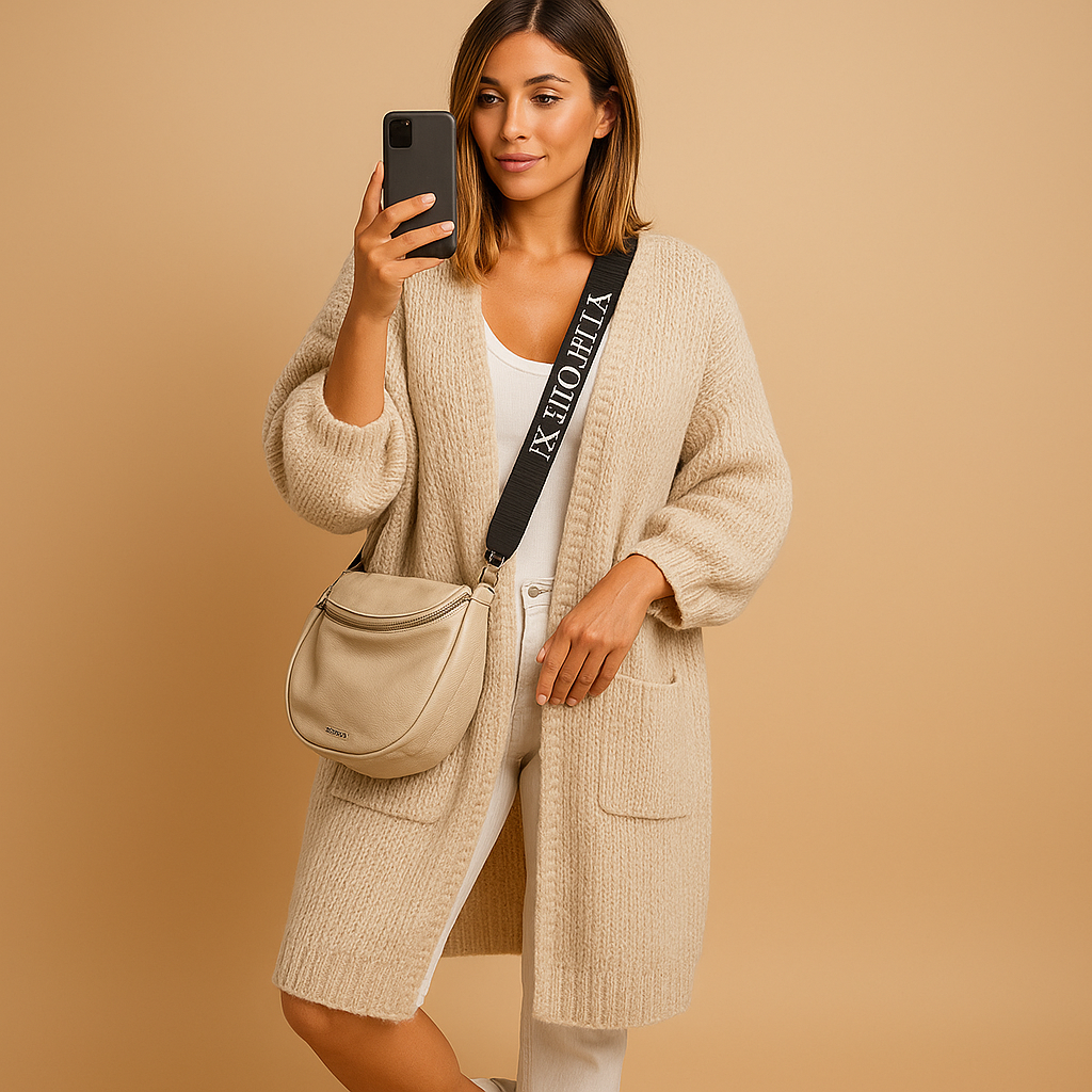 Women’s oversized open front cardigan with flowing fabric, chic tailored details, and neutral tones, ideal for layering in casual or stylish outfits.